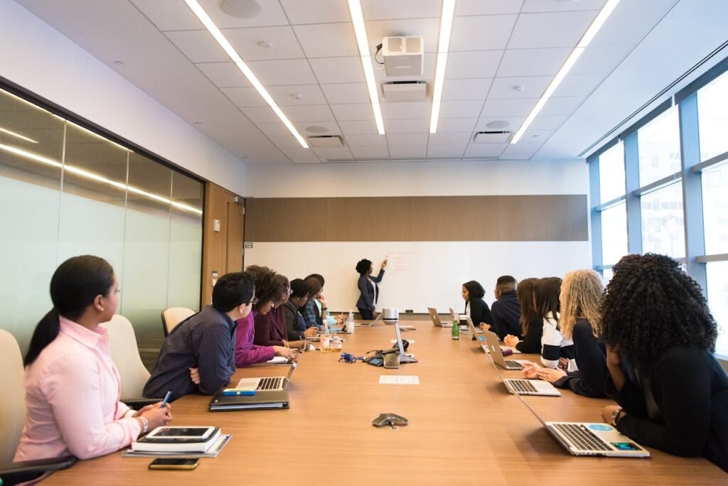 Tips for Managing Stress at Work 2 Beawareofmecom A professional woman leading a meeting in a modern boardroom showcasing female leadership in the workplace