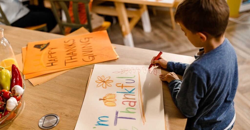 kids Discipline That Builds Beawareofmecom A young boy colors a Thanksgiving themed poster at a table highlighting how gentle parenting actually affects kids by encouraging creativity gratitude and emotional expression in a calm environment