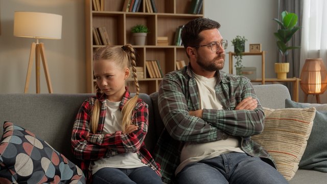 Frustrated Caucasian parent dad male talking family guy daughter arguing at home angry child crossing arms father kid turning away little girl man avoid each other trouble psychology conflict indoors Beawareofmecom 17 Signs of Parental Alienation You Should Know About