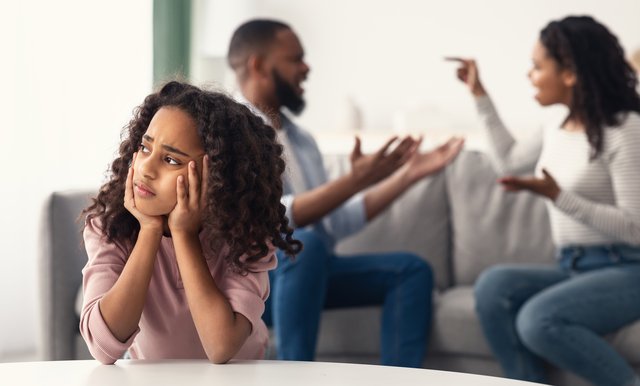 Sad black girl with her fighting parents in the background Beawareofmecom 17 Signs of Parental Alienation You Should Know About