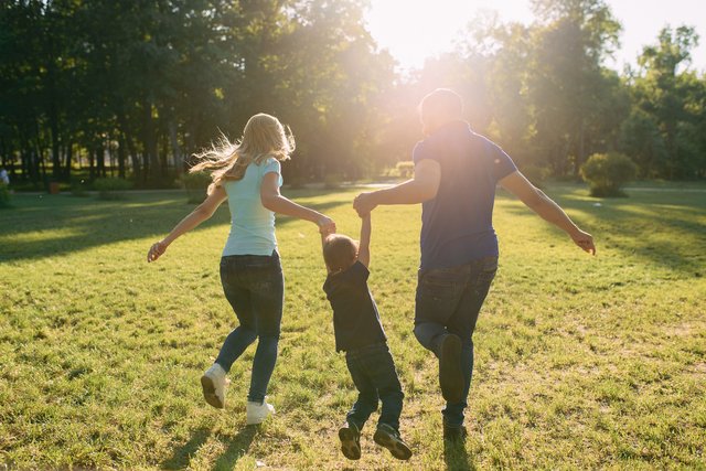 Parents play in the park with their son Beawareofmecom Indiana Parenting Time Guidelines Explained Clearly