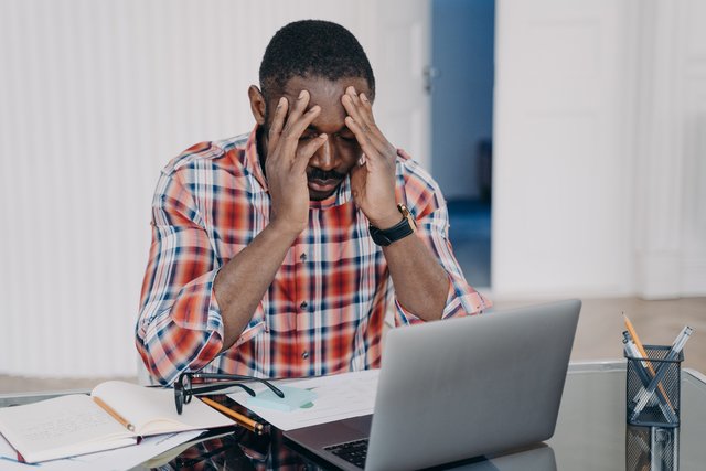 Exhausted african american man suffer headache at laptop Stress at work occupational burnout Beawareofmecom Burnout Quotes