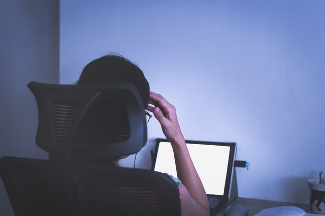 Stressed businesswoman hand on her head working on laptop late a Beawareofmecom Burnout Quotes