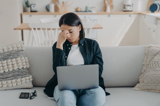 Overworked woman suffer eye fatigue headache tired from working at laptop sitting on couch at home Beawareofmecom Burnout Quotes